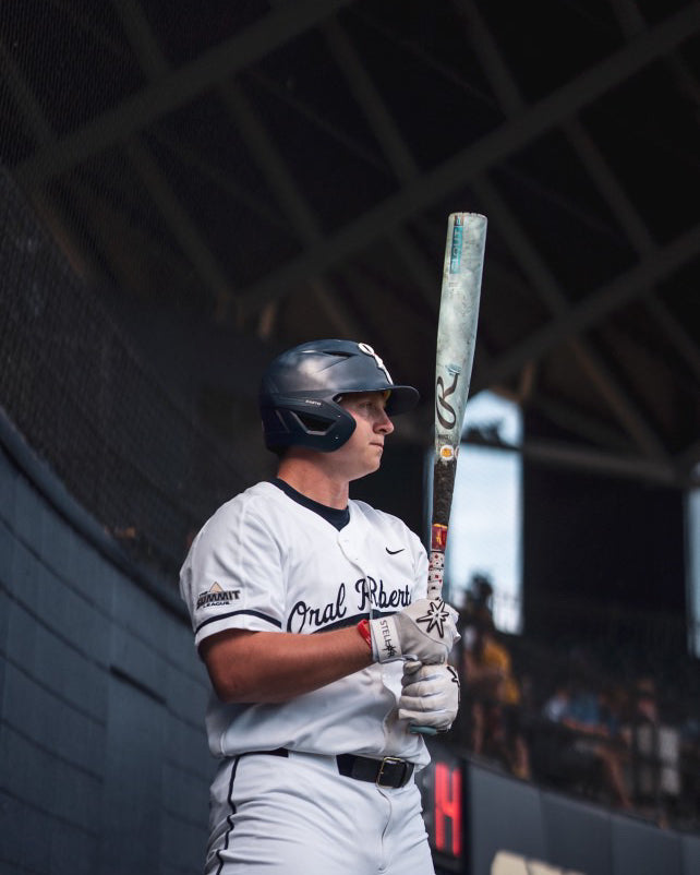 Baseball player holding a bat in a stadium setting