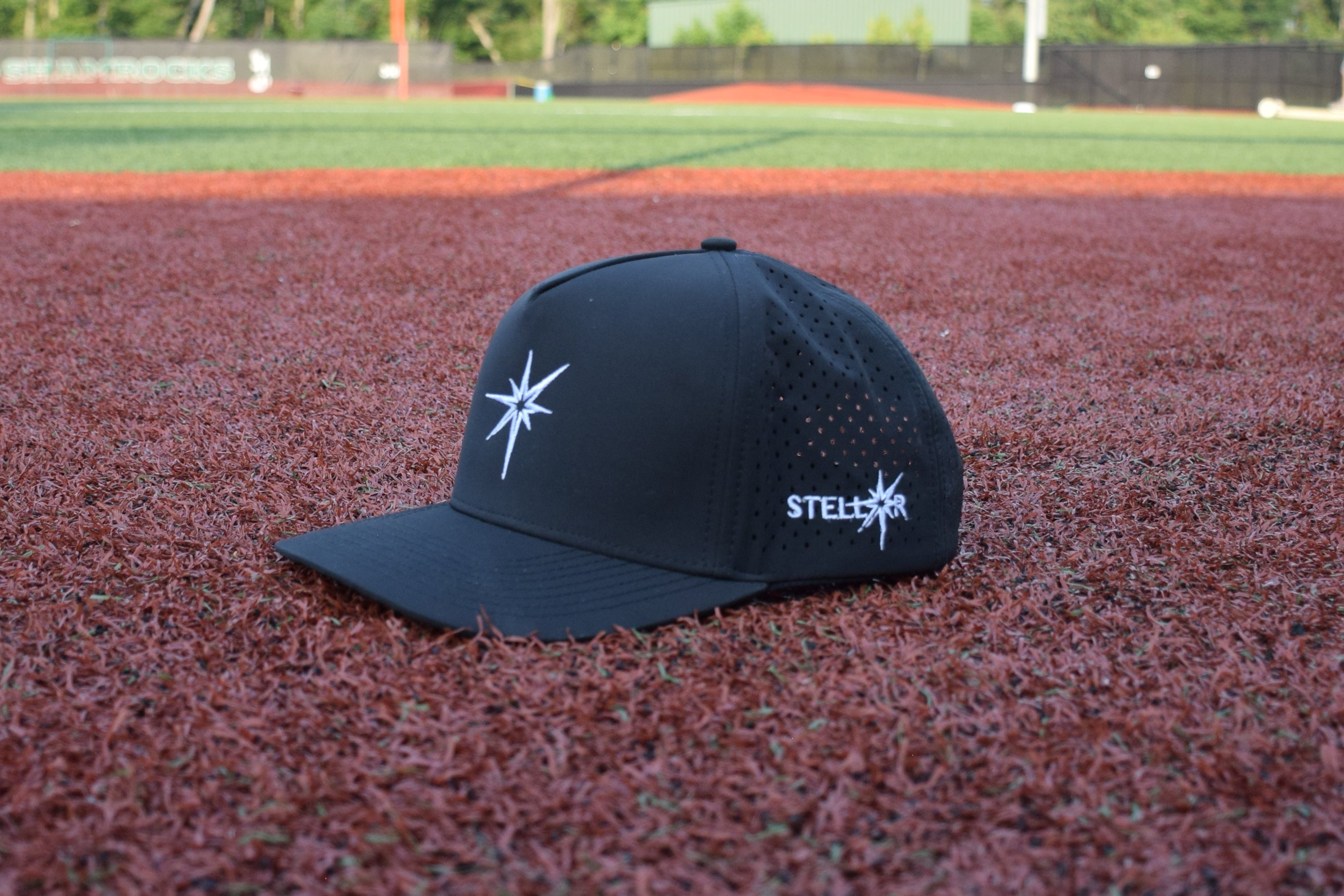 A black baseball cap featuring a star logo, showcasing the collection of Hats.