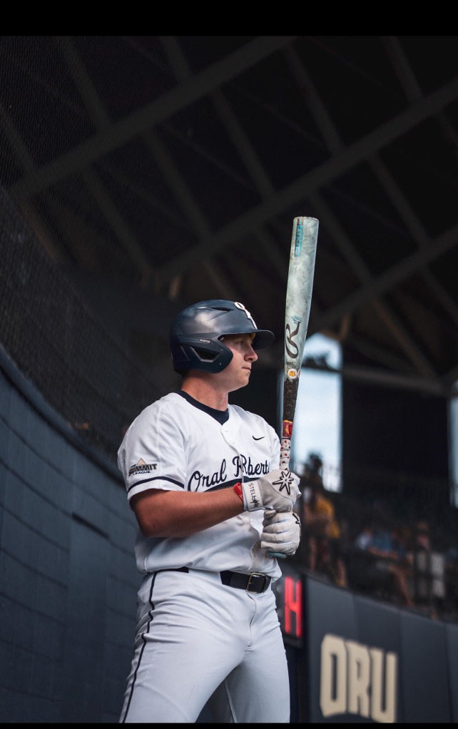 Baseball player holding a bat in a stadium setting